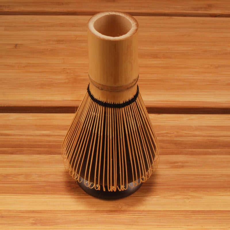 matcha whisk on top of black holder